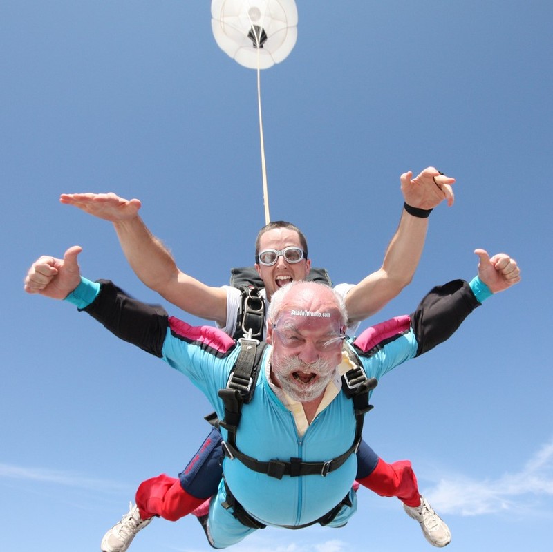 photo of two men mid air skydiving