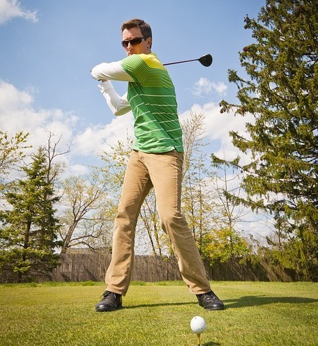 photo of a man swinging a golf club