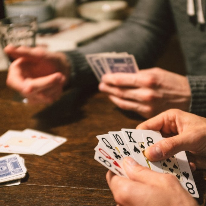 photo of close of hand of cards