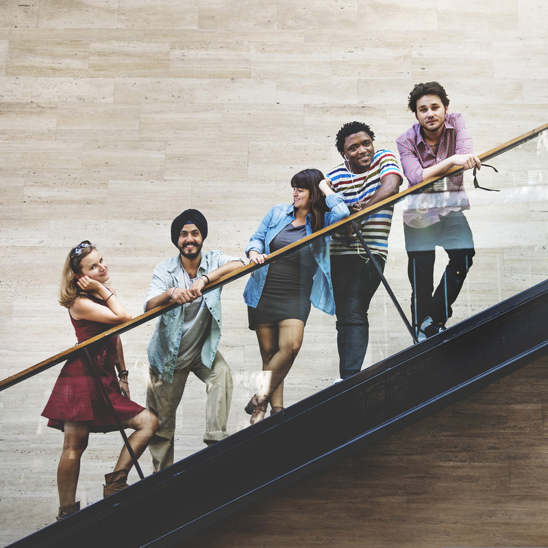 photo of five people posing on a flight of stairs