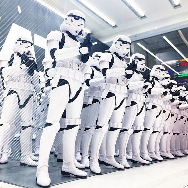 A line of identically dressed stormtroopers from the Star Wars films.