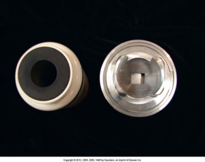 An image of two parts of a radiology device, with one part showing a circular opening and the other displaying a metallic component with a rectangular aperture, part of an X-ray collimator system.