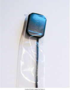 A dental digital sensor with a blue top is encapsulated in a clear protective plastic sleeve, indicating it's ready for intraoral use while maintaining hygiene, provided by Gendex Imaging, Des Plaines, IL.