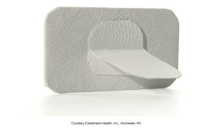 A textured bite-wing tab holder used in dental radiography to position and stabilize X-ray films inside the mouth, provided by Carestream Health, Inc., Rochester, NY.