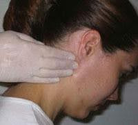 a young woman being examined for retroauricular lymph nodes