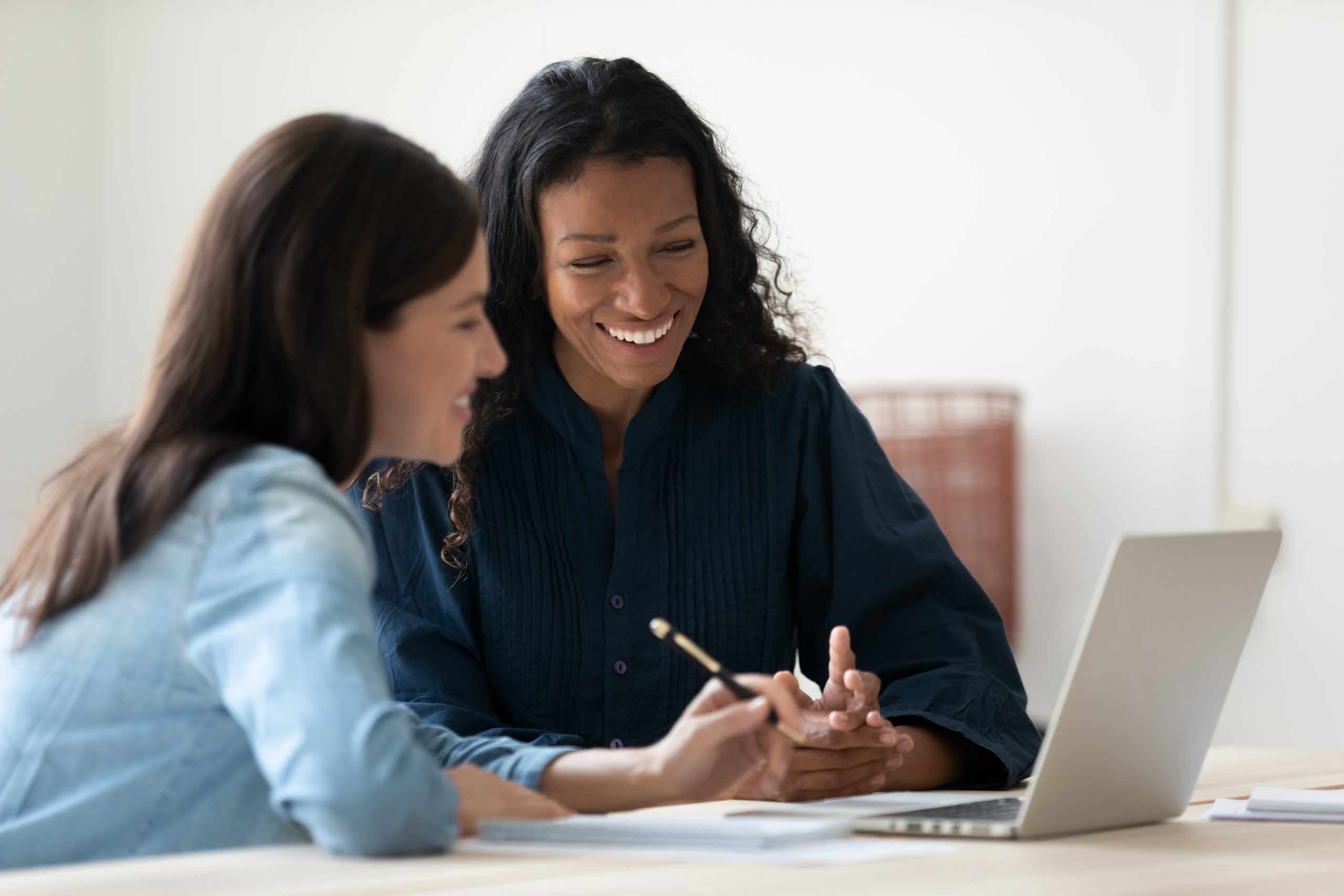 Decorative image of two women working together on a laptop.