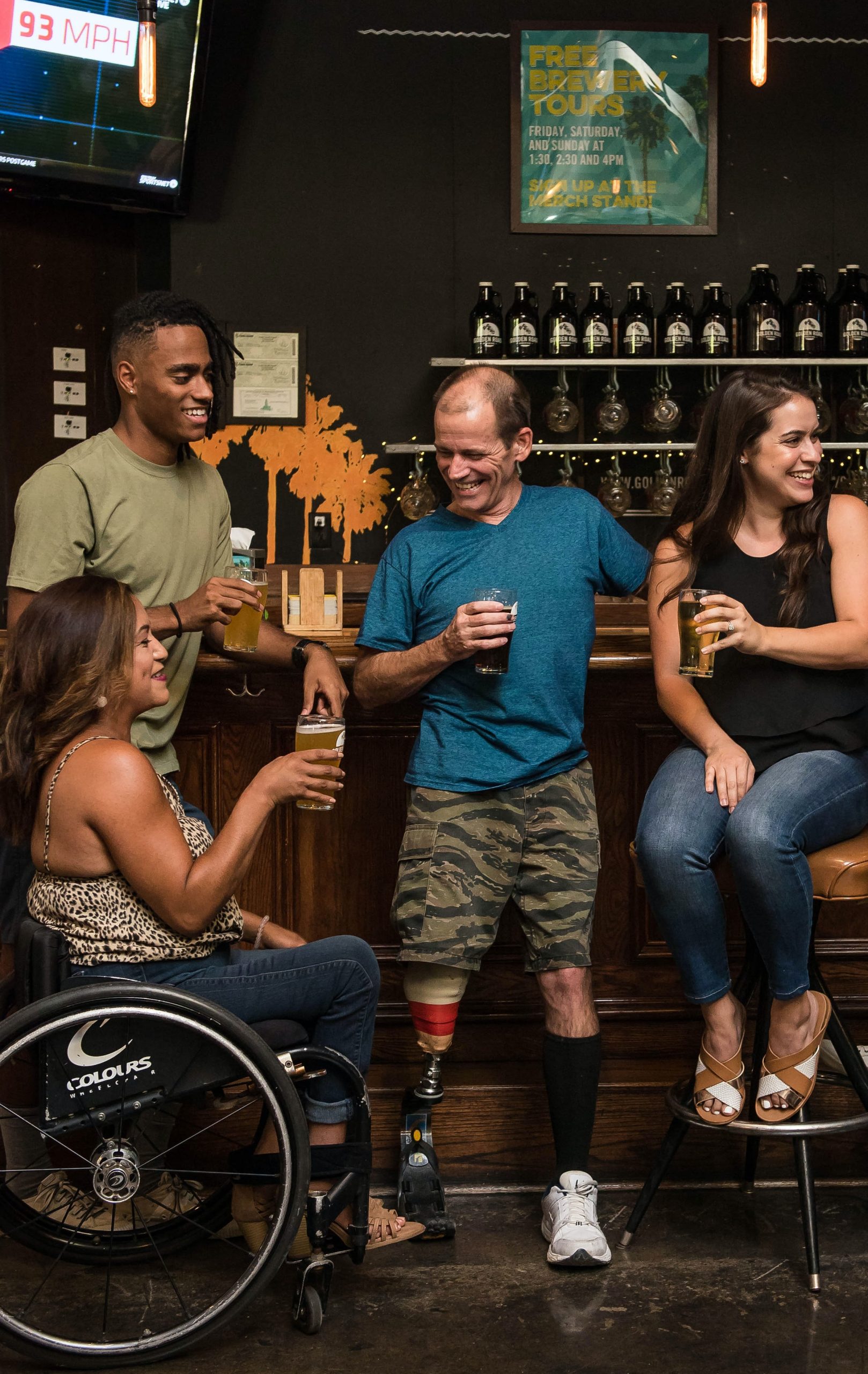 Decorative image of four students at a pub socializing.