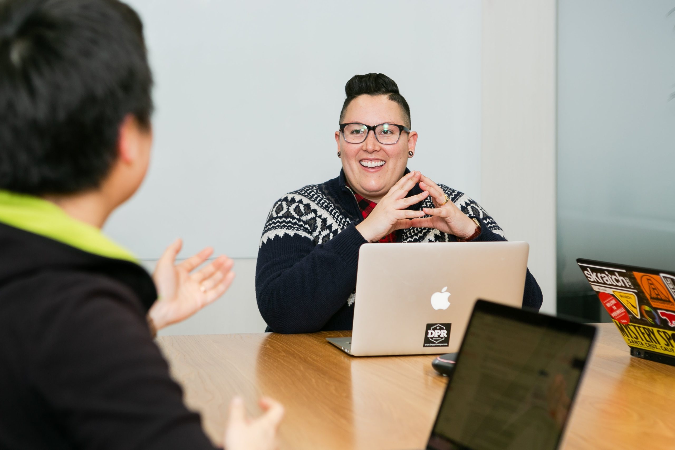 Decorative photograph of a school's academic advisor meeting with a student at a table.