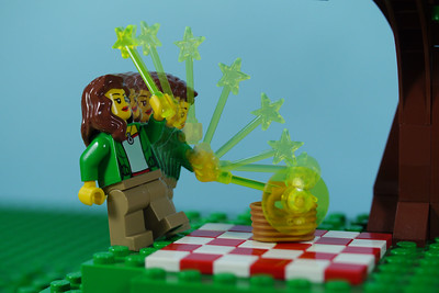 A lego character holds a wand, multiple photos overlapped to show the wand moving.