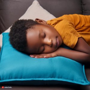 a child laying on a blue pillow, appears to be asleep