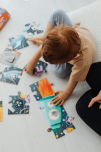 Child playing with jigsaw puzzle