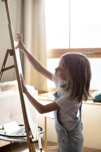 Girl painting on easel