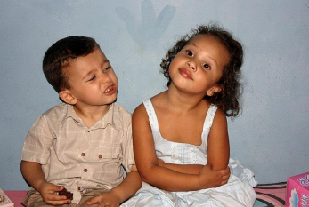 a boy and a girl sitting side by side