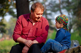 a father and child talking to each other outside