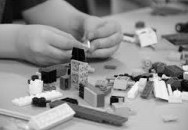 Photo of hands playing with lego.