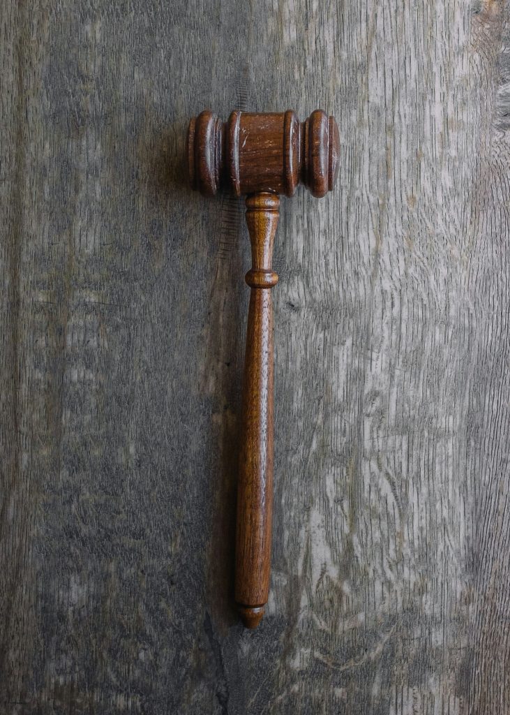 brown gavel on gray wooden surface