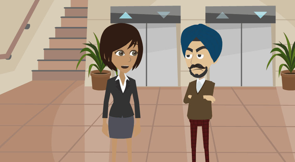 Jane is standing in a lobby speaking to a man. There is a bank of elevators behind them.