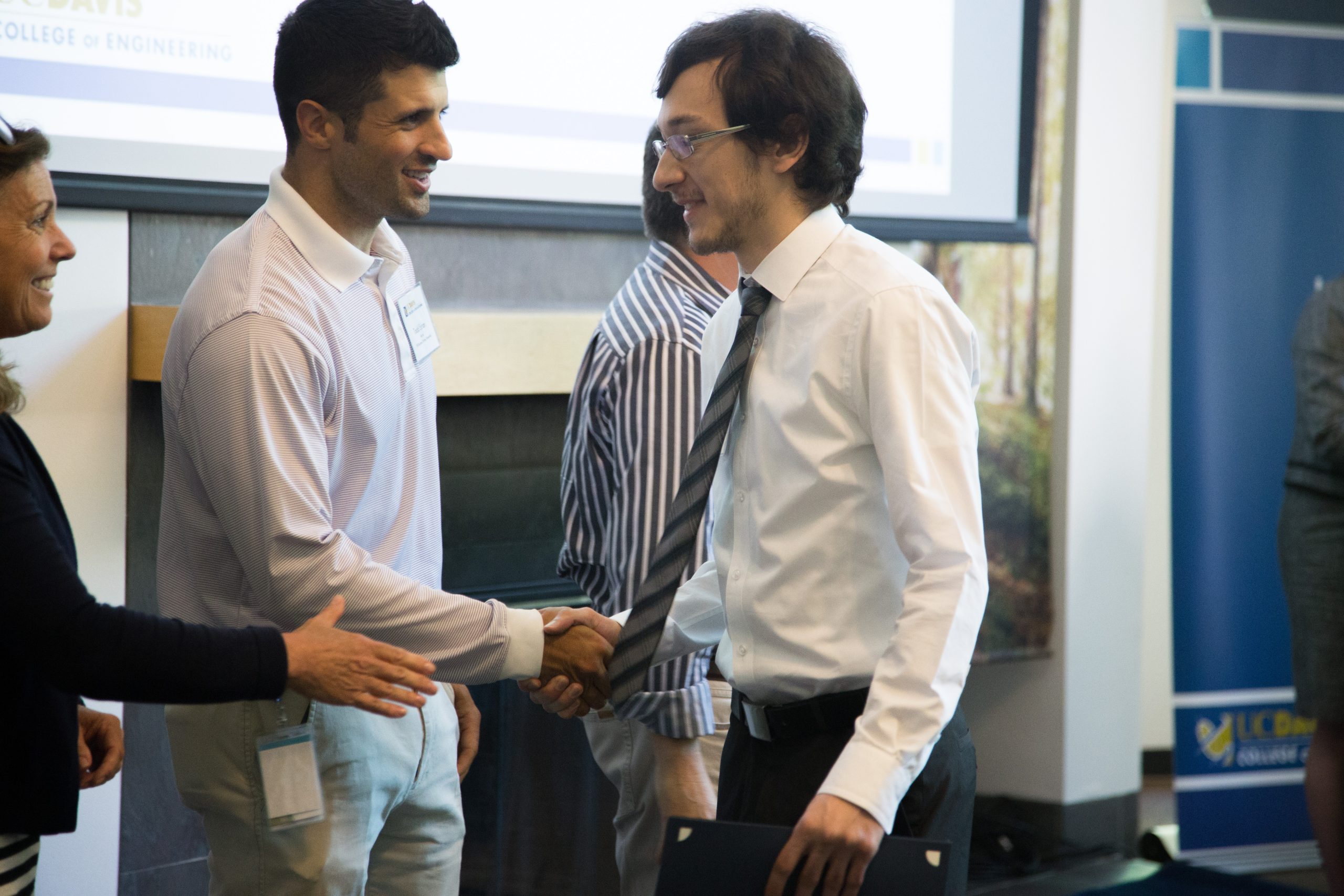 Adult students meeting for the first time and shaking hands.