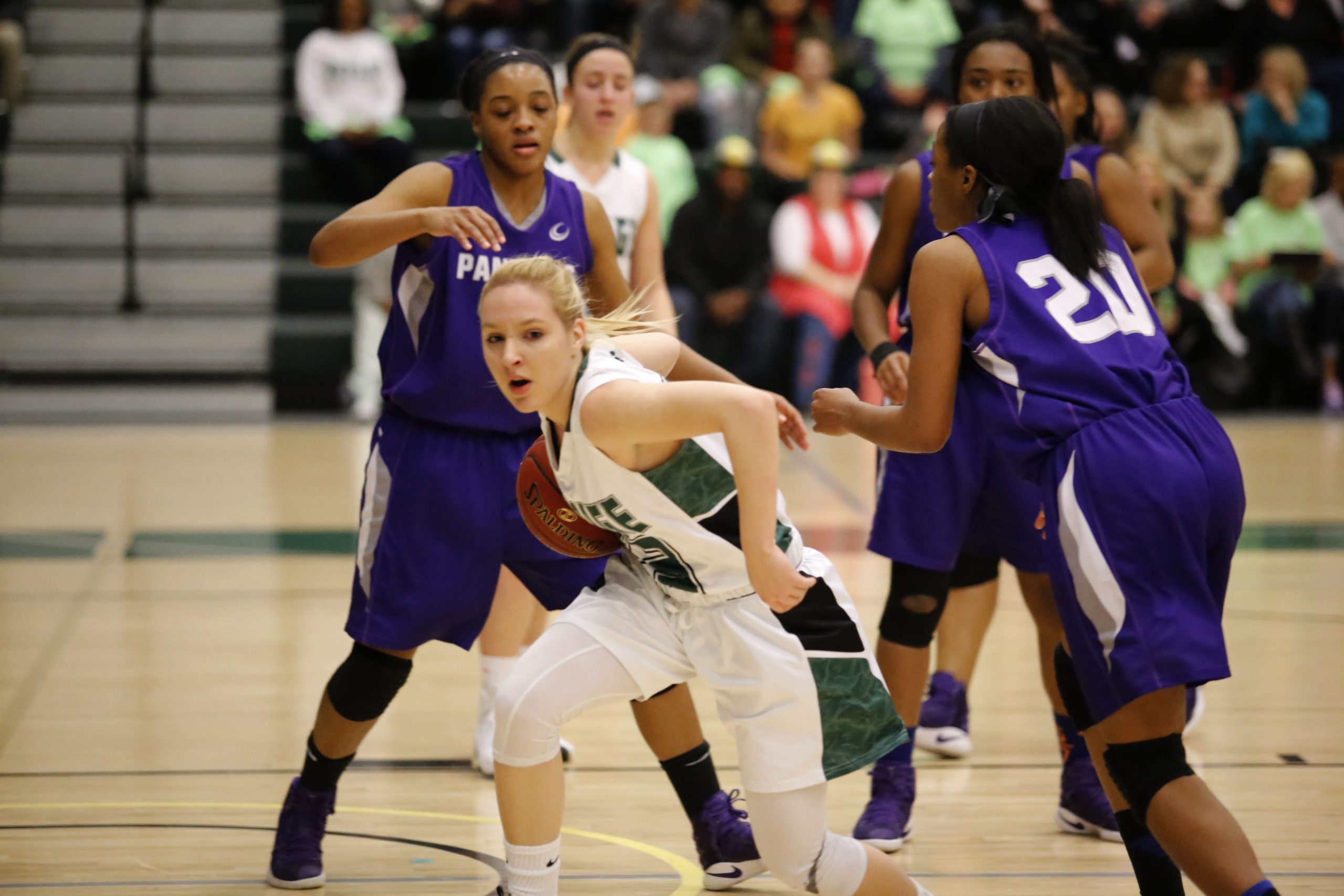 Students playing in a college basketball game.