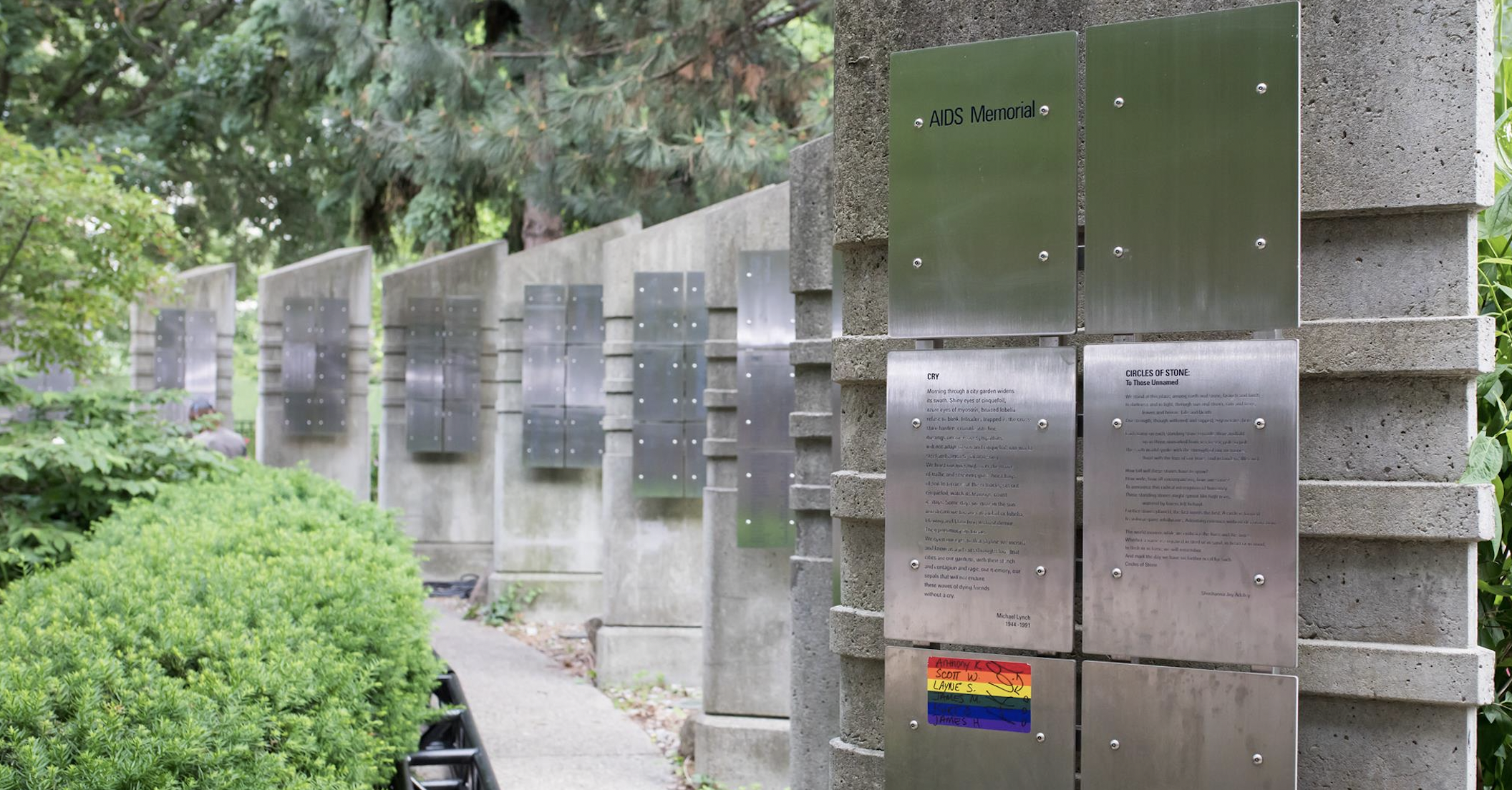 Memorial concrete pillars with metal plates engraved with names of people who died of AIDS.