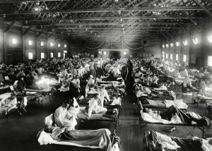 patients lying in beds in emergency hospital during influenza epidemic, Camp Funston, Kansas (1918). Original image from National Museum of Health and Medicine.