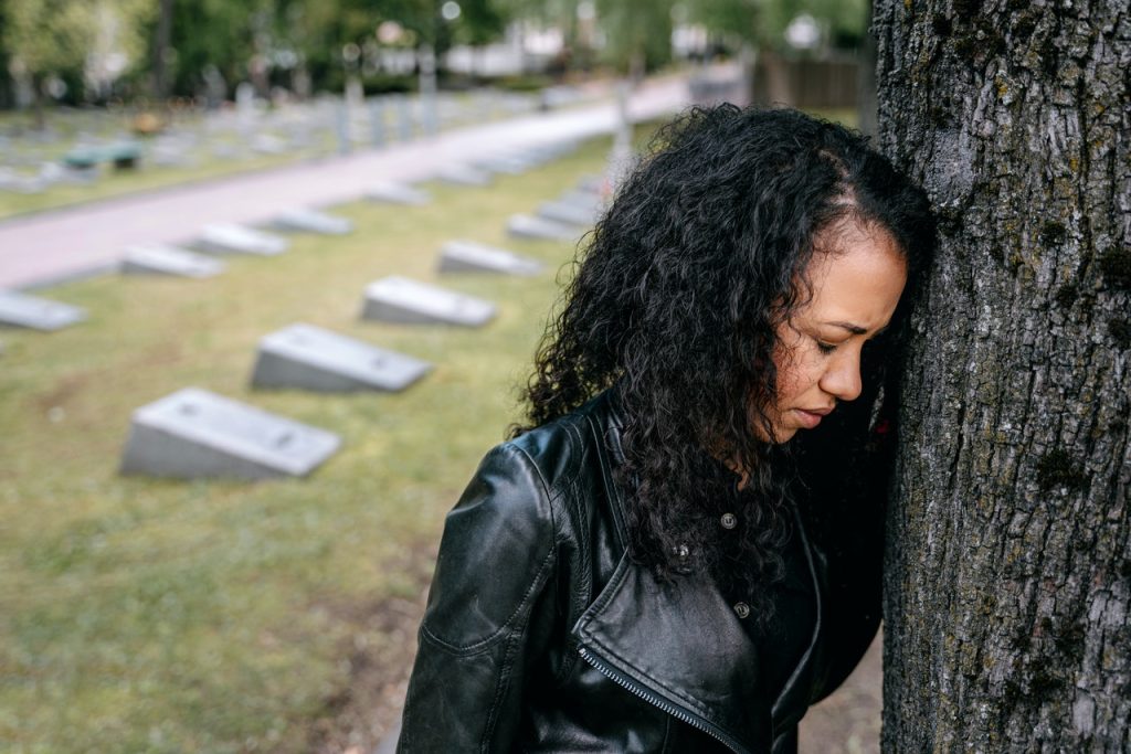 Woman Leaning Her Head on the Tree Trunk