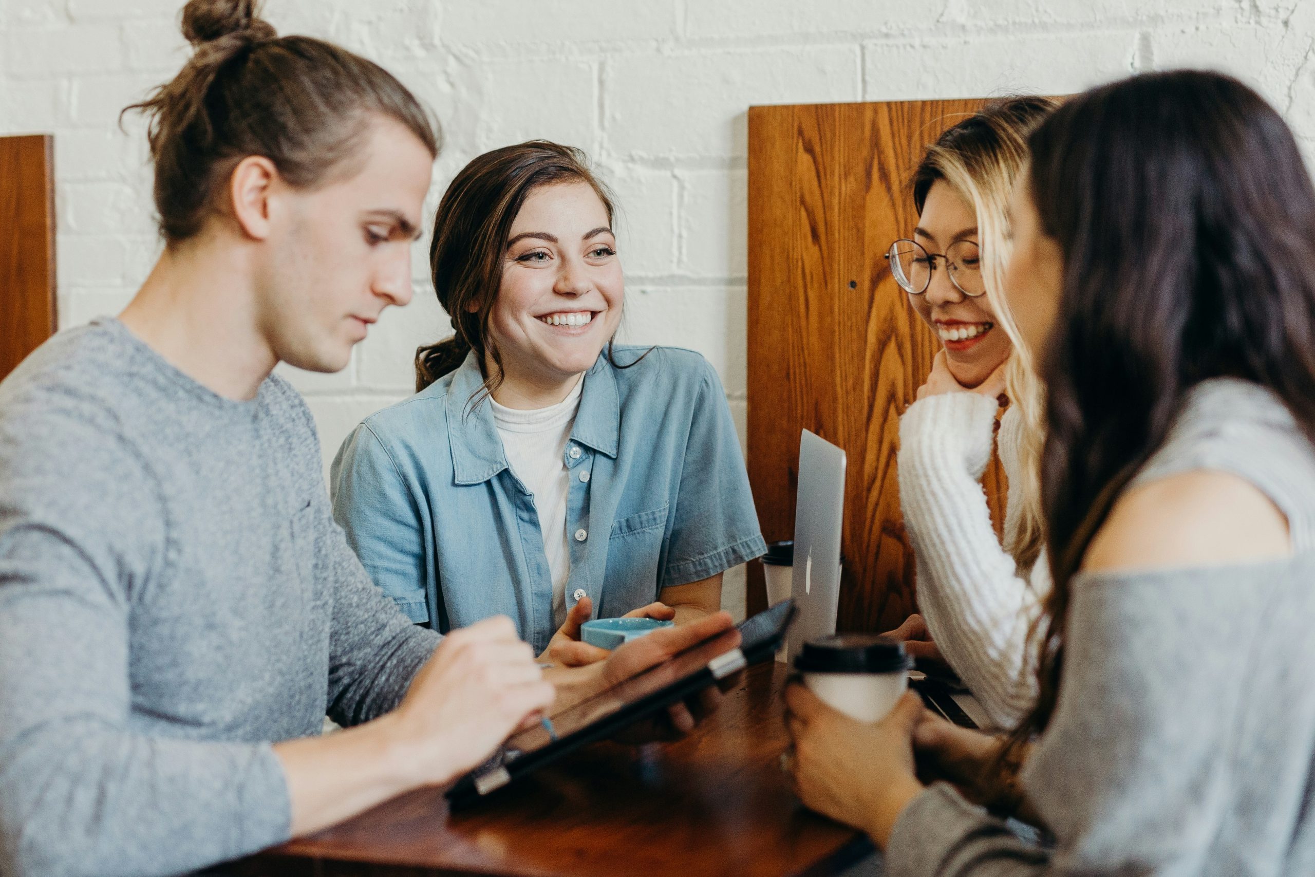 Image of a group of friends at a coffee shop.