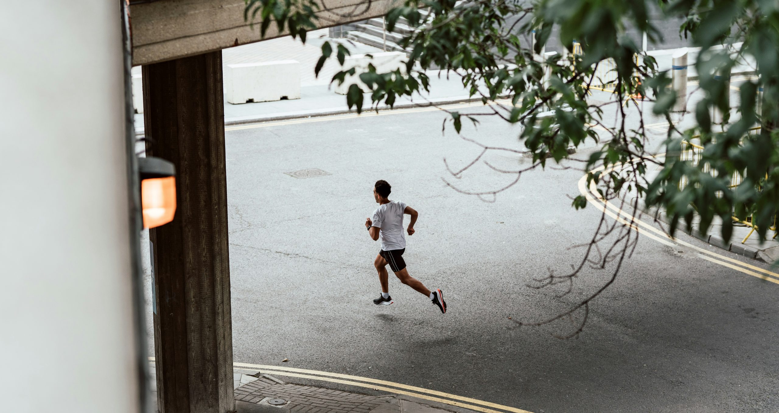 Image of a young man running down a street.