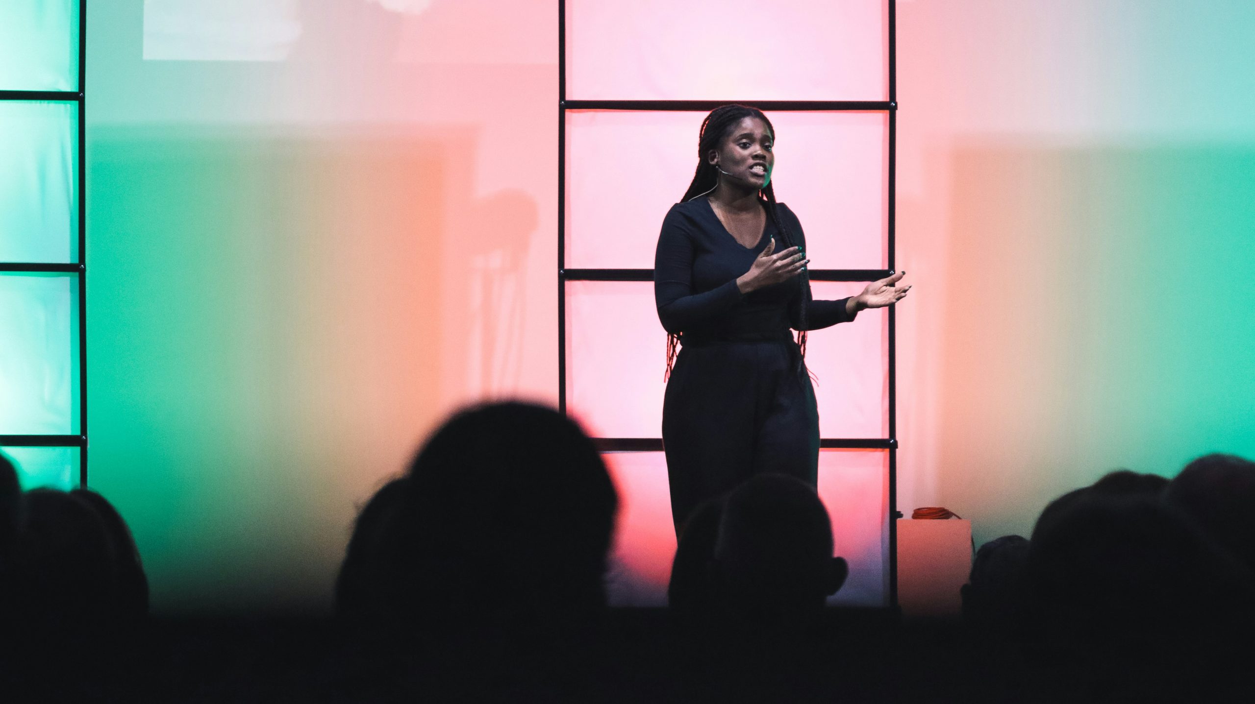 Image of a woman speaking on a stage.