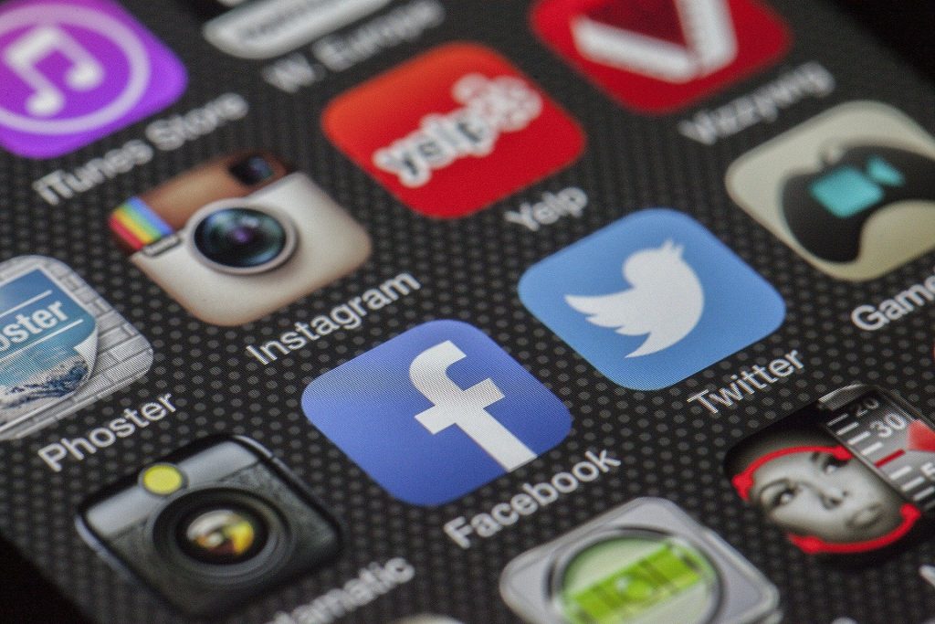 Several social media app icons on a phone screen.