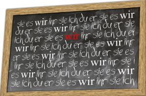 Chalk board with German pronouns (ich, du, er, sie, es, wir, ihr, sie, Sie)