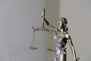 Statute of a blindfolded woman holding the scales of justice.