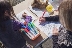 Two children colouring at a table.