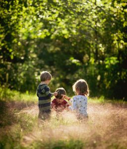 Three children playing outside.