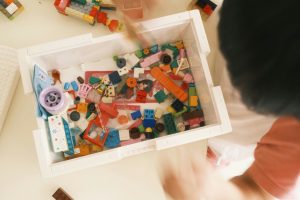 A young child playing with lego.