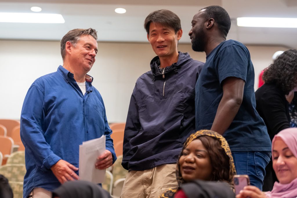 Fanshawe students having a conversation in a lecture hall.