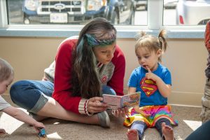 ECE worker reading a book to a child