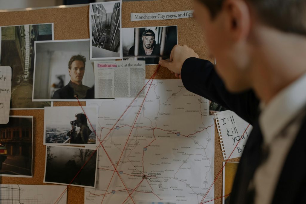 Detective looking at clues on a bulletin board