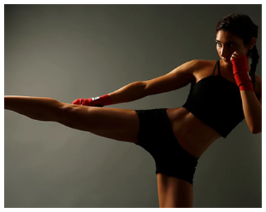 A woman kickboxing.
