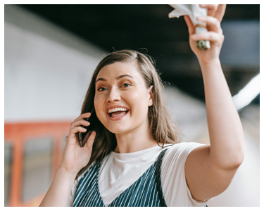 A woman smiling and waving.