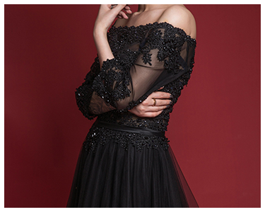 A woman in a formal black ball gown.