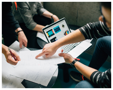 Students helping each other on an assignment.