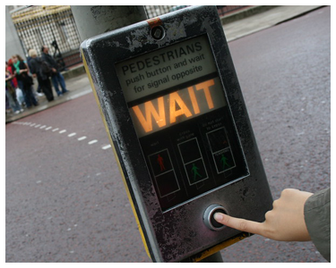 A pedestrian signal that says 'WAIT.'