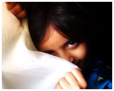 A girl covering her face.