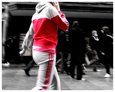 A person wearing a gray and red track suit.