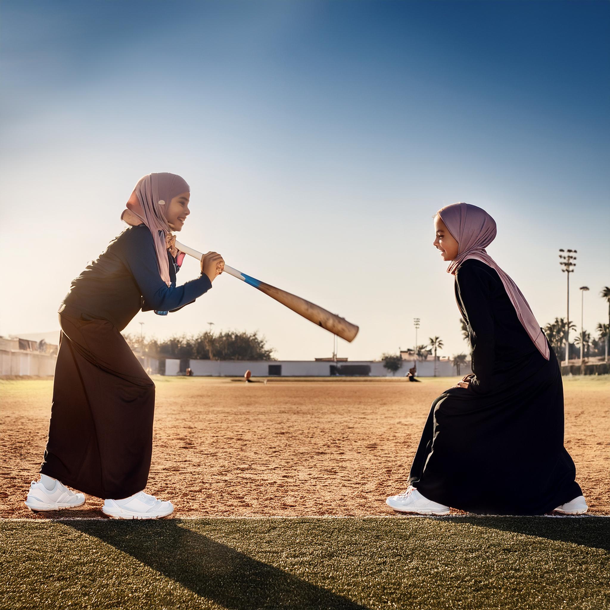 Twin ten-year-old sisters from Syria playing baseball.