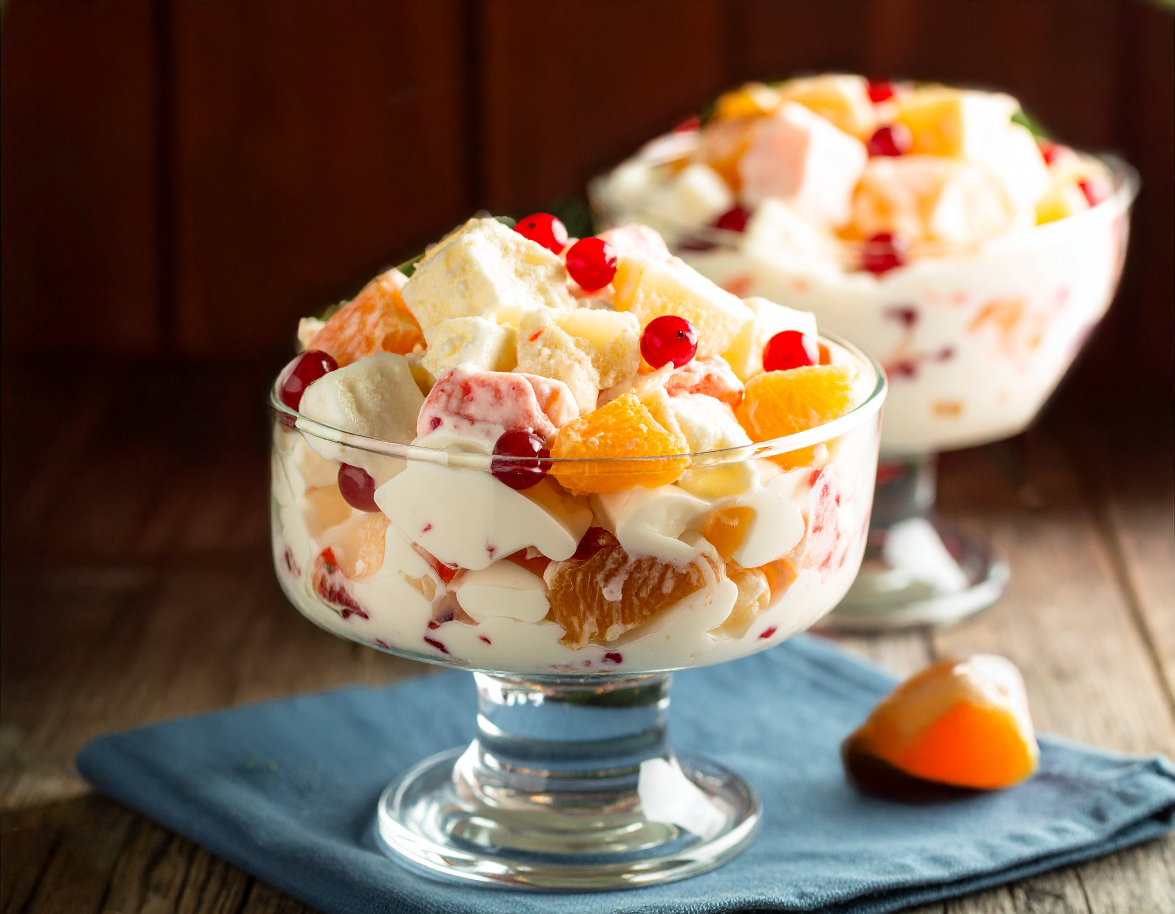 Two glass bowls of 5 Cup Salad on a wood table.