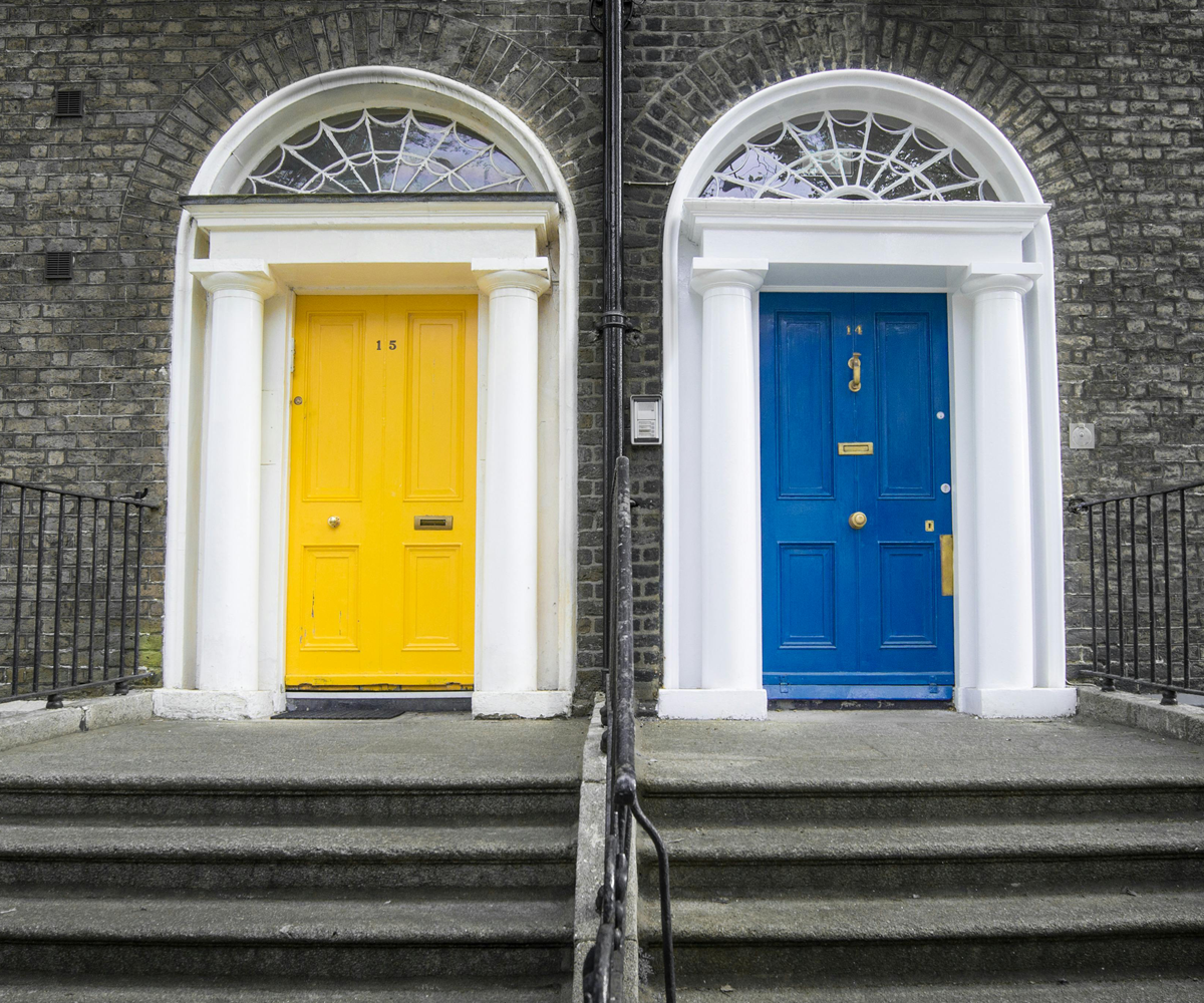 Two brightly coloured doors next to each other.