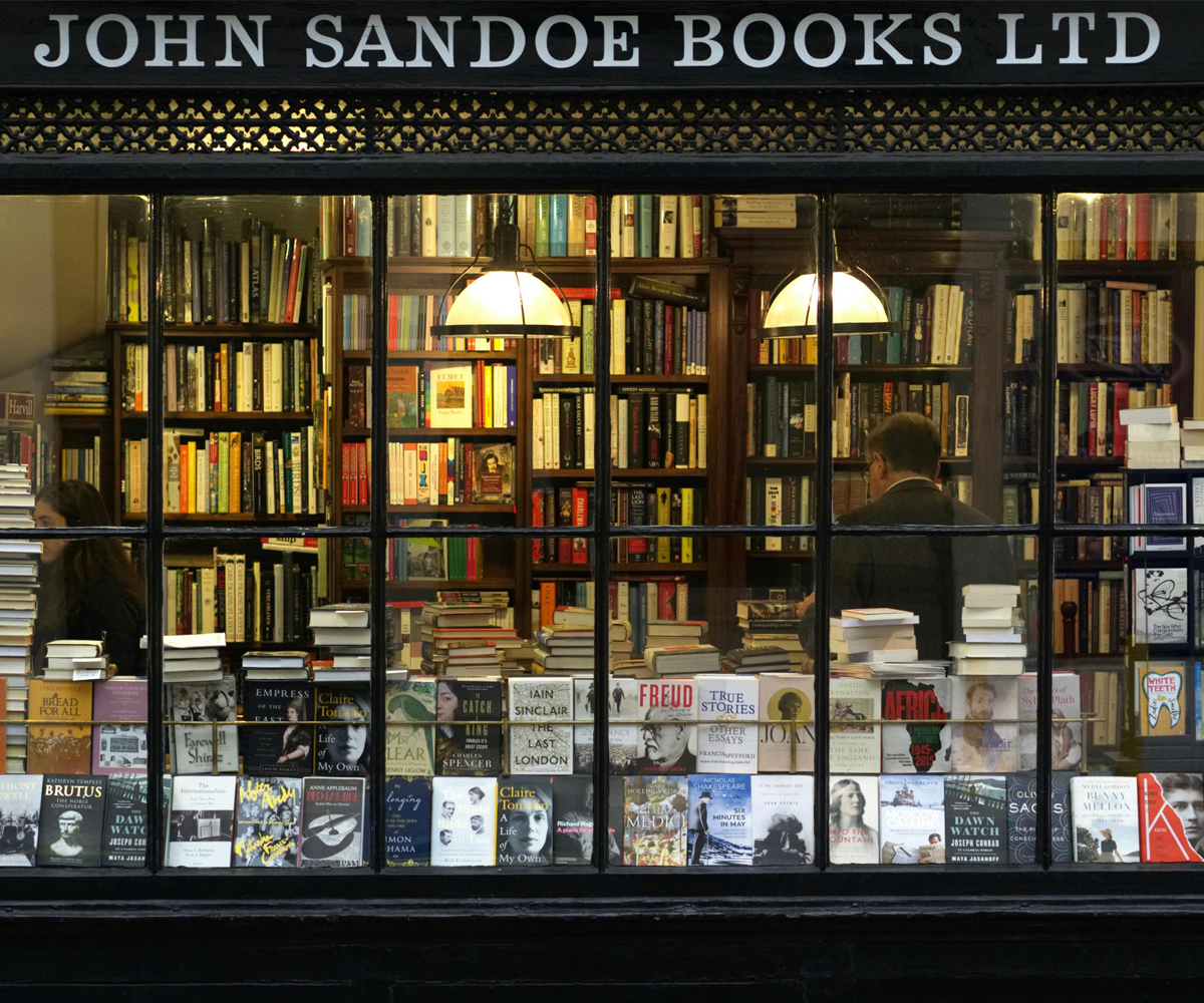 The front window of a small bookstore with a sign that reads 'John Sandoe Books Ltd.'