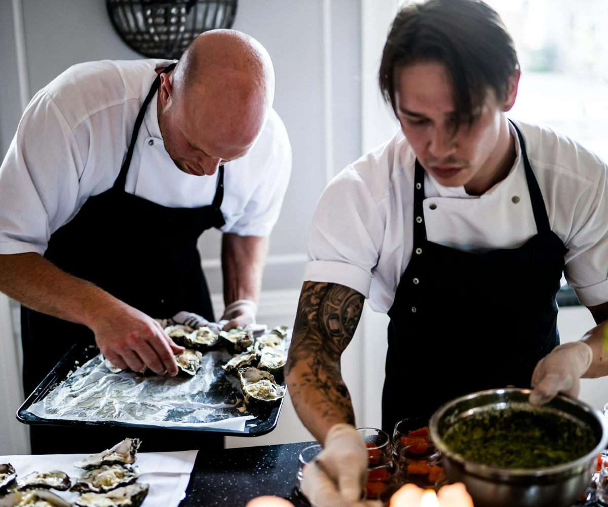 Two chefs preparing food.